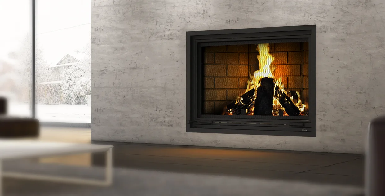 A Valcourt wood fireplace burning in a pale concrete wall beside a window onto snow